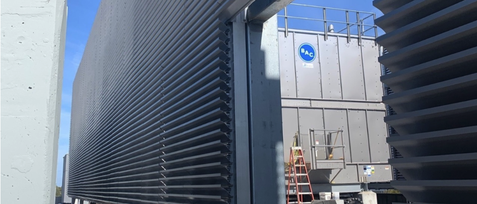 Aluminum louvers surround an industrial zone on an urban building.